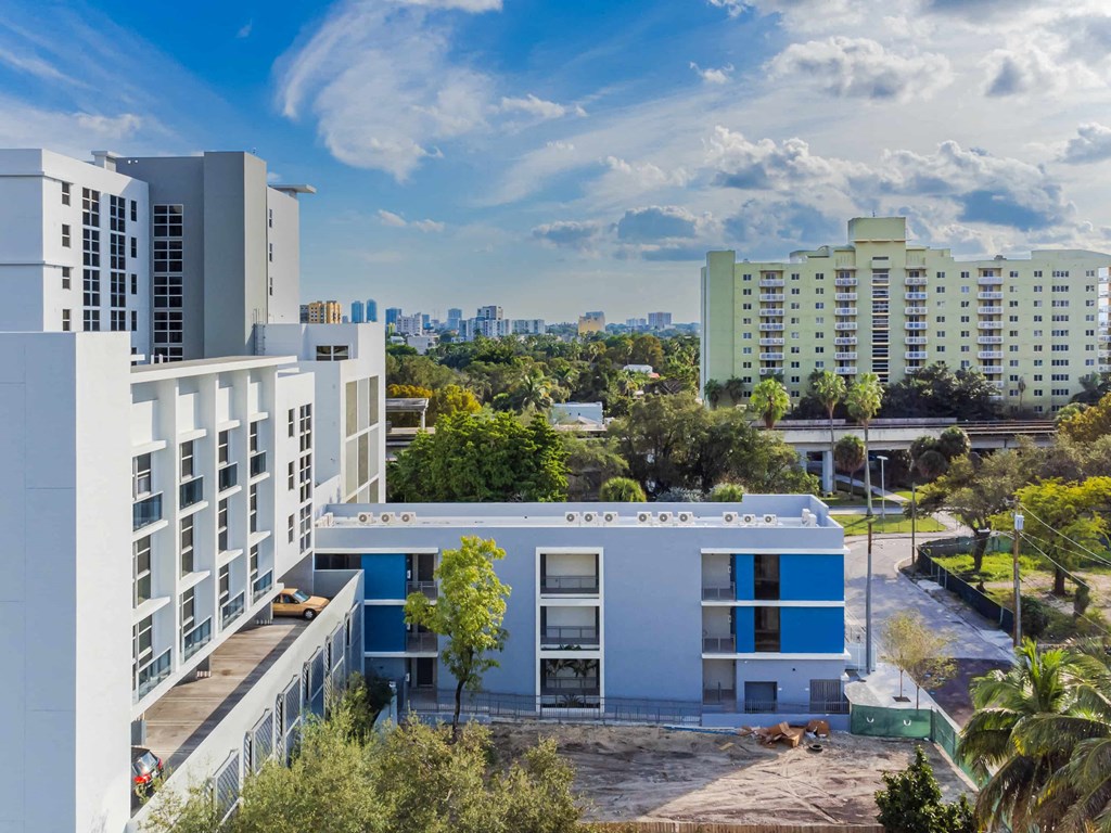 a large blue and white building with a city in the background