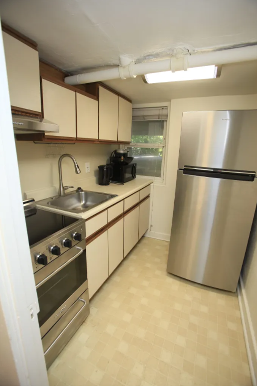 a kitchen with a sink and a refrigerator