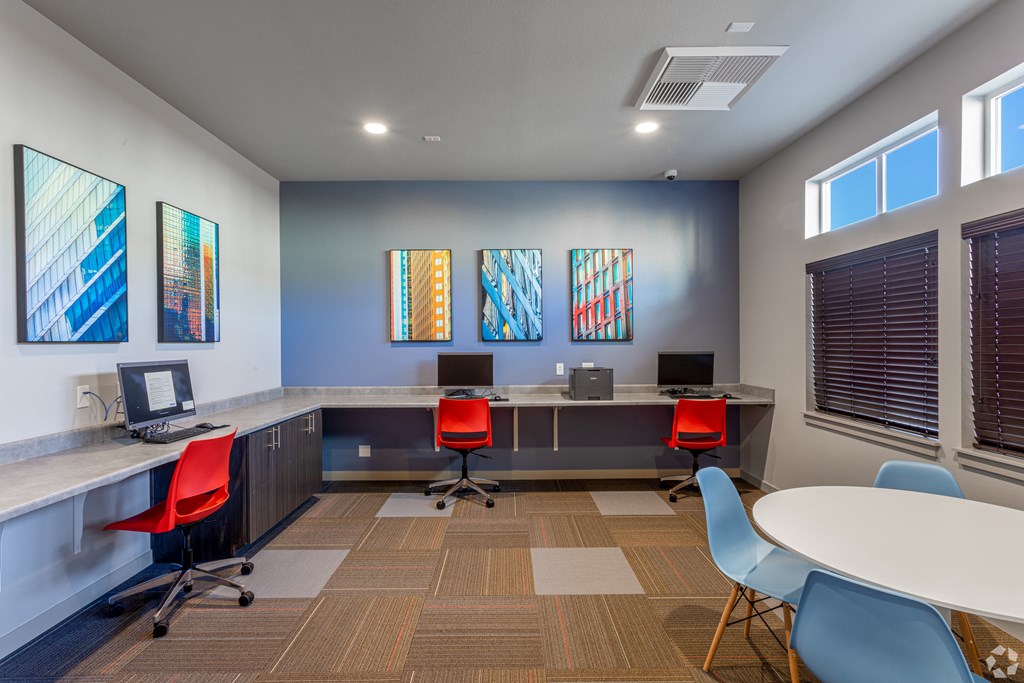 a conference room with desks and chairs and computers