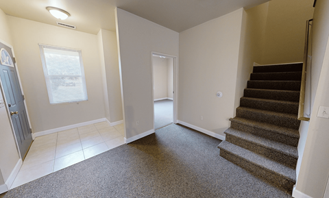 A room with a staircase and a window.