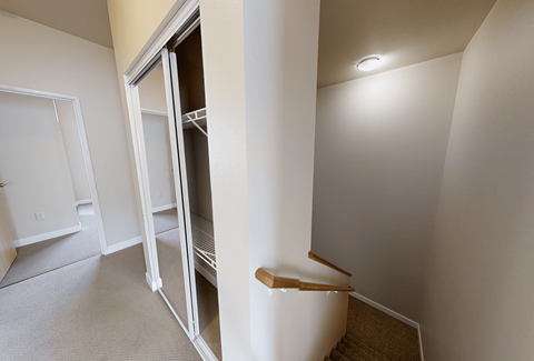 A white column in a room with a white door.