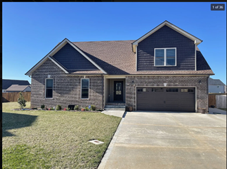 a house with a driveway and a garage door