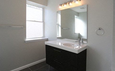 a bathroom with a white sink and a mirror