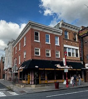 a brick building on the corner of a city street