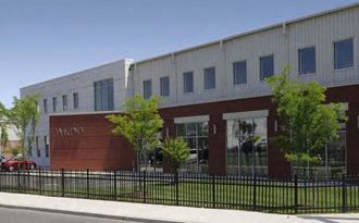 a large building with a fence in front of it
