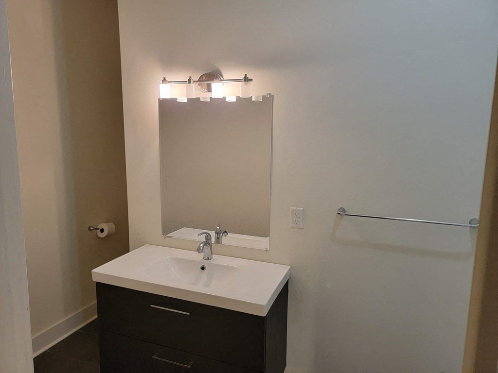 a small bathroom with a sink and a mirror