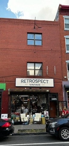a red brick building with a store sign on the front of it