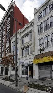 a street corner with tall buildings and a street light