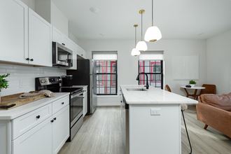 a kitchen with an island and a stove and a window