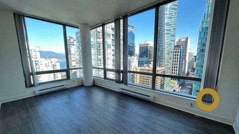 an empty living room with a view of the city