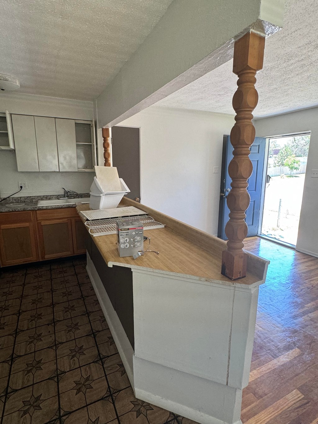 an empty kitchen with an island in the middle of it