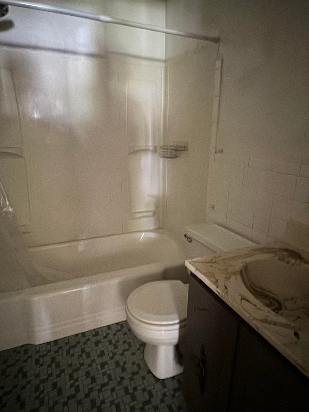 an empty bathroom with a toilet and a tub