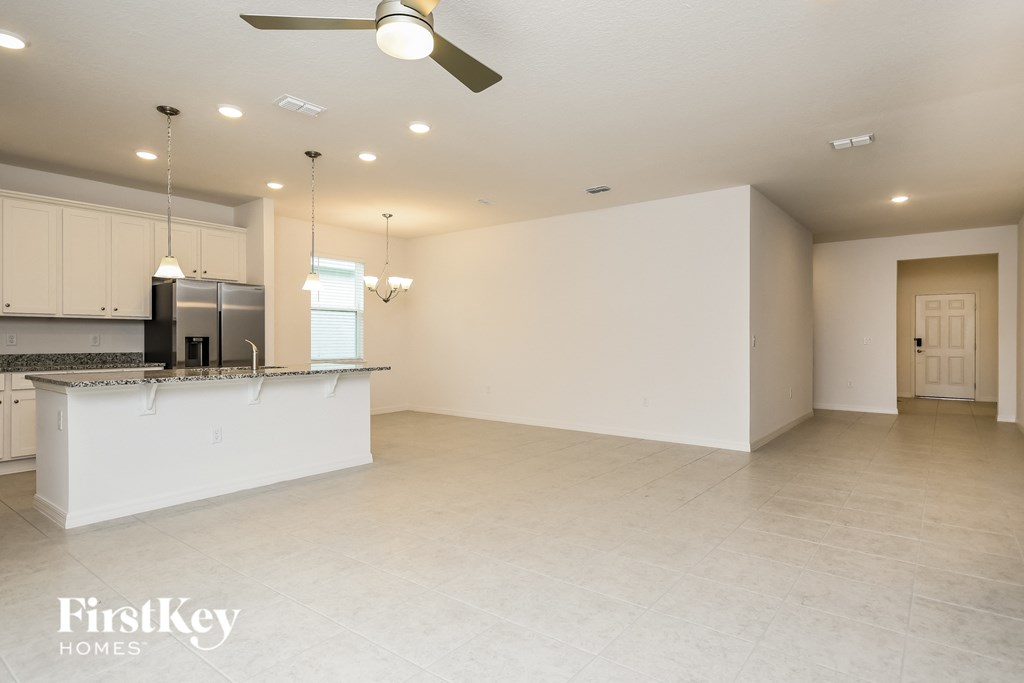 an empty kitchen and living room with a large counter top