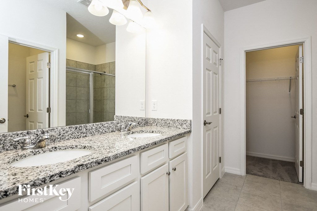 a bathroom with two sinks and a large mirror
