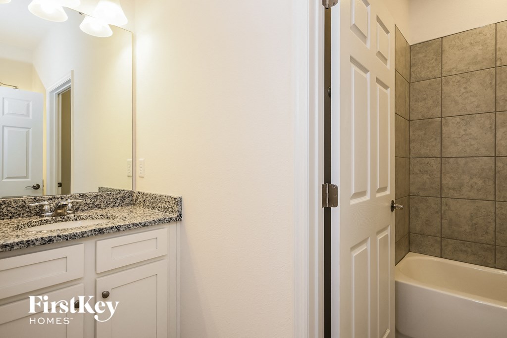 a bathroom with a sink and a tub and a shower