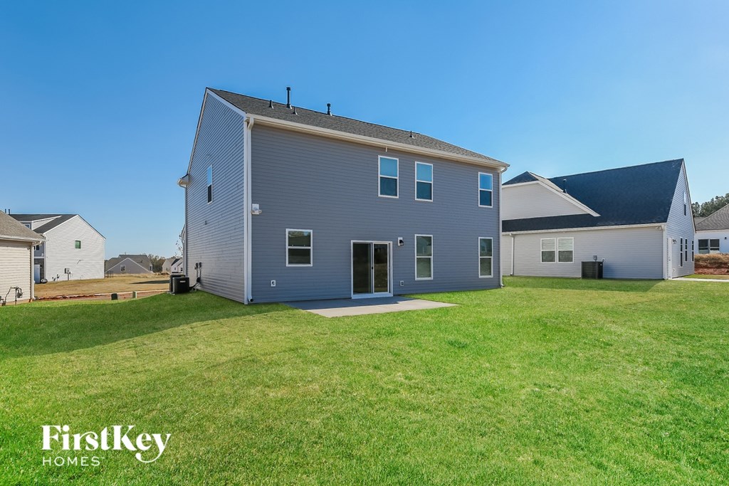 A house with a grey exterior and a black roof is shown with the words "FirstKey Homes" on the bottom left.