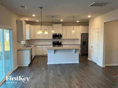 a kitchen with white cabinets and a counter top