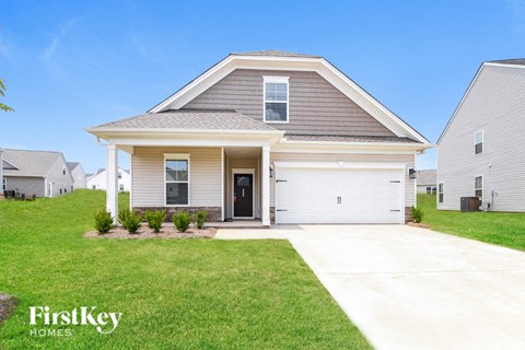 a beige house with a white garage door