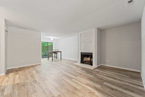 a living room with a fireplace and a wooden floor