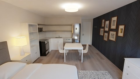 a small living room with a table and a kitchen