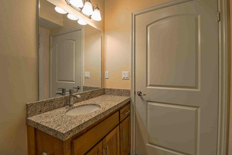 a bathroom with a sink and a white door