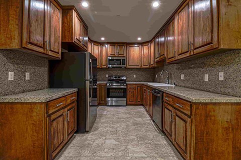 a kitchen with wooden cabinets and stainless steel appliances