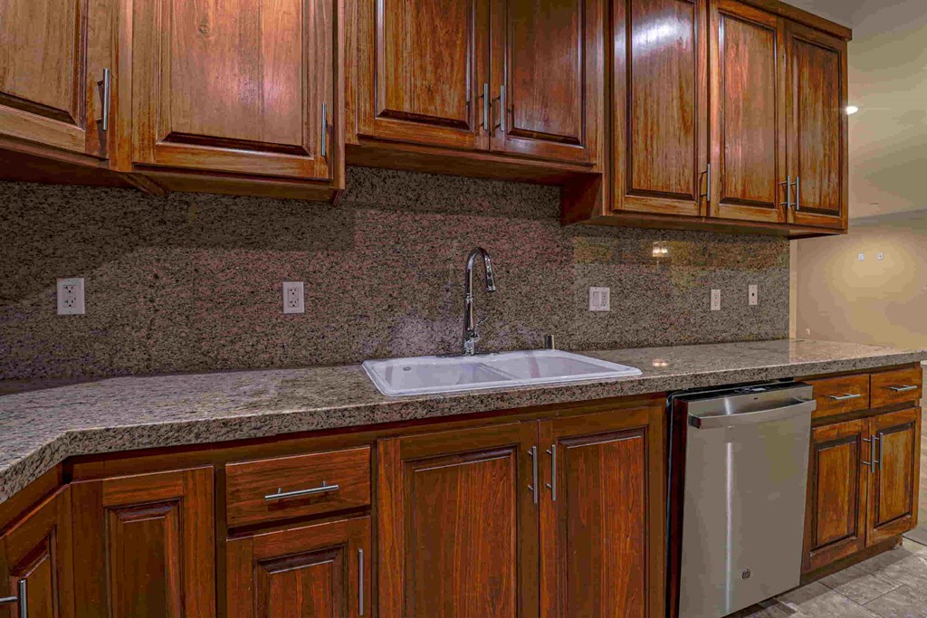 a kitchen with wooden cabinets and a sink