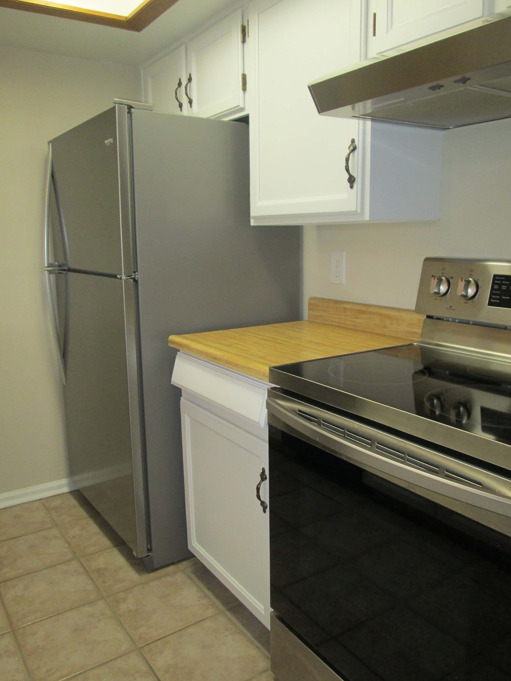 a kitchen with a stove and a refrigerator