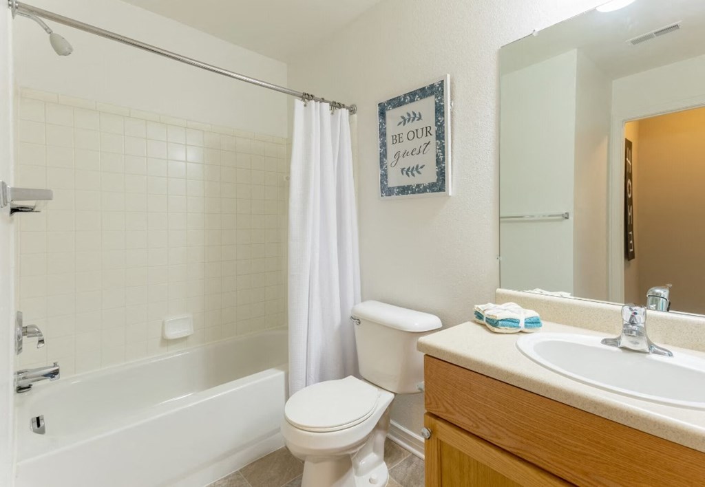 a bathroom with a sink toilet and a bath tub