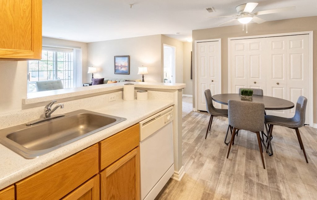 a kitchen and dining room with a sink and a table
