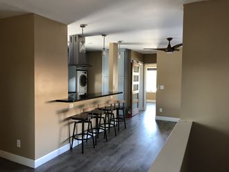 an open kitchen with a bar and a living room