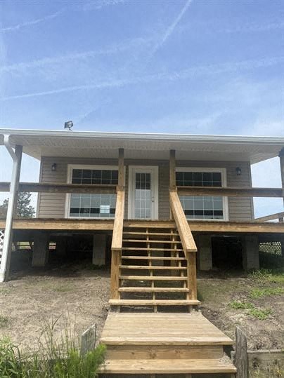 a house with a porch and stairs in front of it