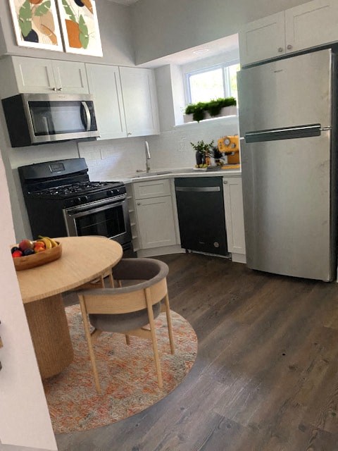 a kitchen with stainless steel appliances and a small table
