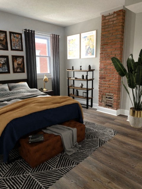 a bedroom with a bed and a brick fireplace