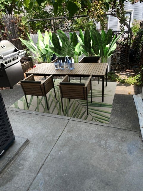 a patio with a wooden table and chairs on it