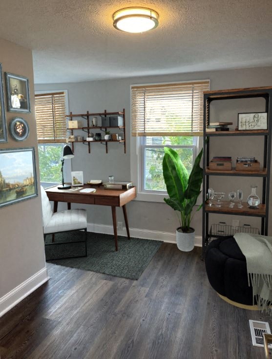 a home office with a desk and a plant