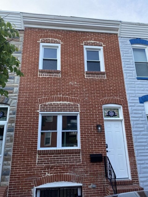 a brick building with a white door and windows