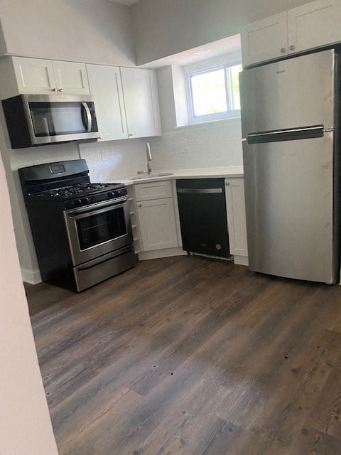 a kitchen with stainless steel appliances and white cabinets