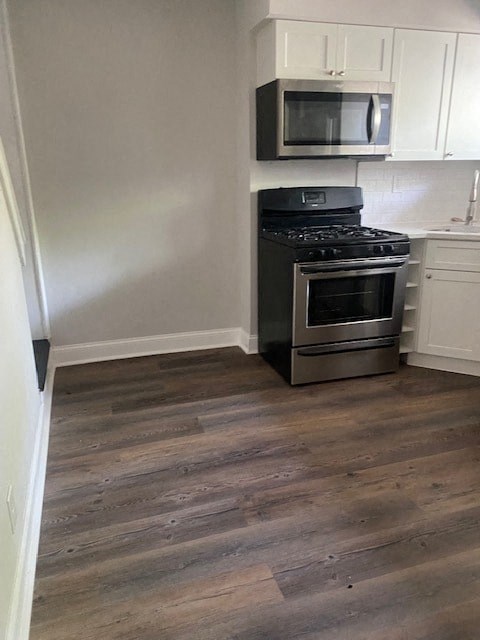a small kitchen with a stove and a microwave
