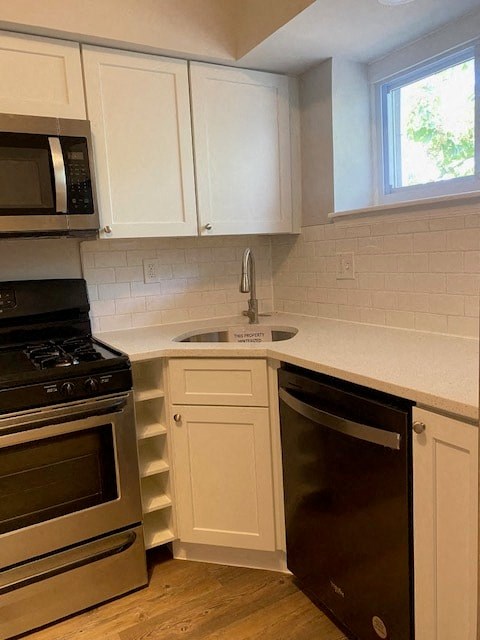 a kitchen with a stove and a sink and a microwave