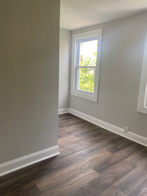 an empty room with wooden floors and a window