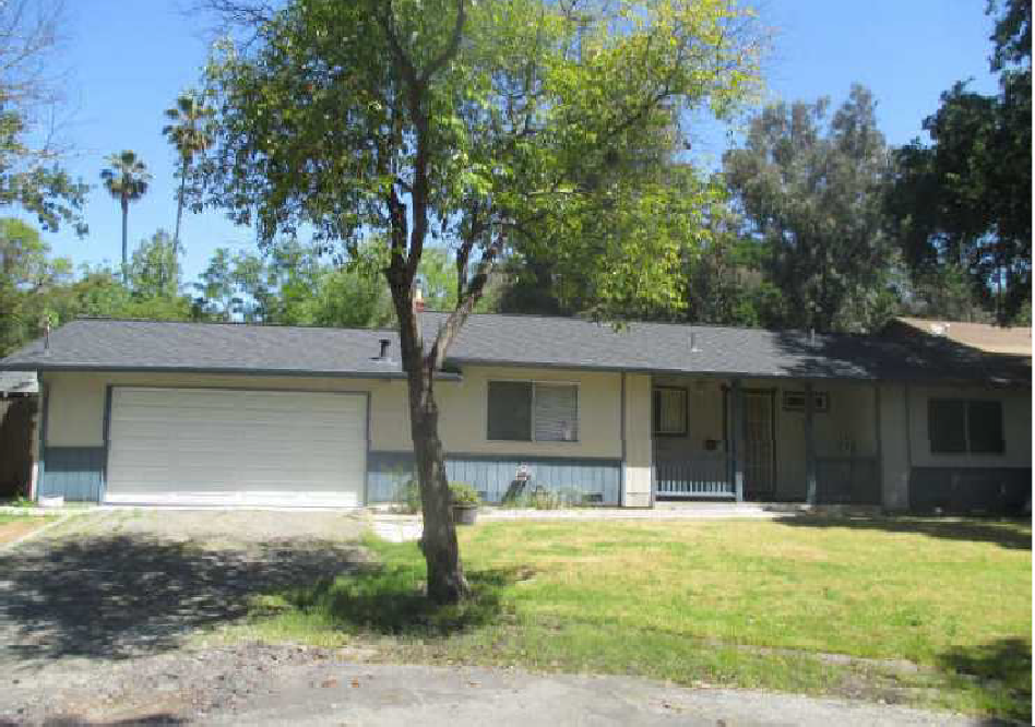 a white house with a tree in front of it