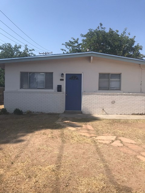 A small house with a blue door and windows.