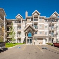 an image of an apartment building with a blue sky in the background