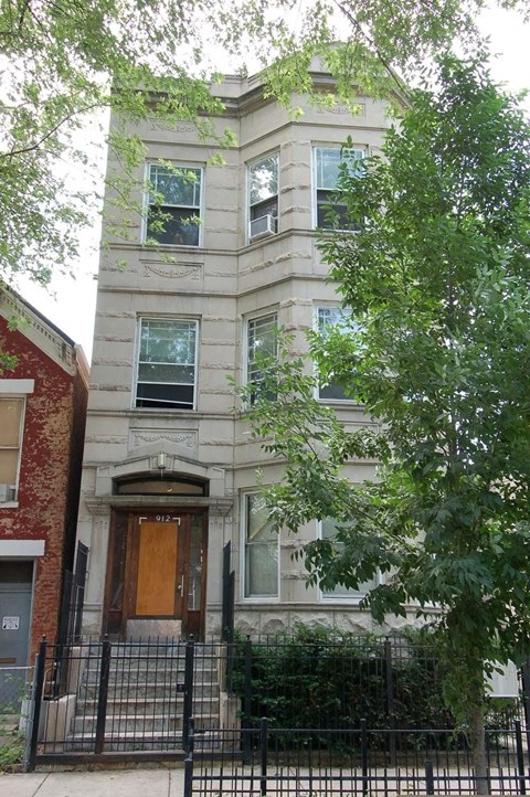 a tall building with a wooden door and windows