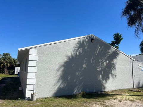 A white building with a shadow cast on it.