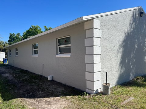 a side view of a house with a blue sky in the background