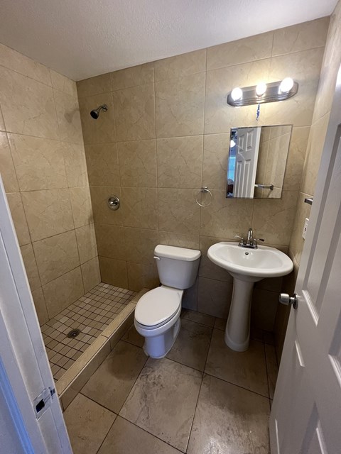 a small bathroom with a toilet sink and shower
