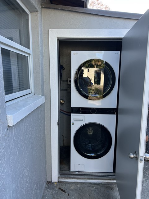 a front door with a washing machine and a dryer in it
