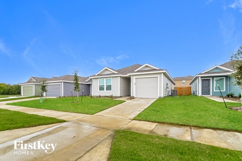 a row of houses on a street with grass